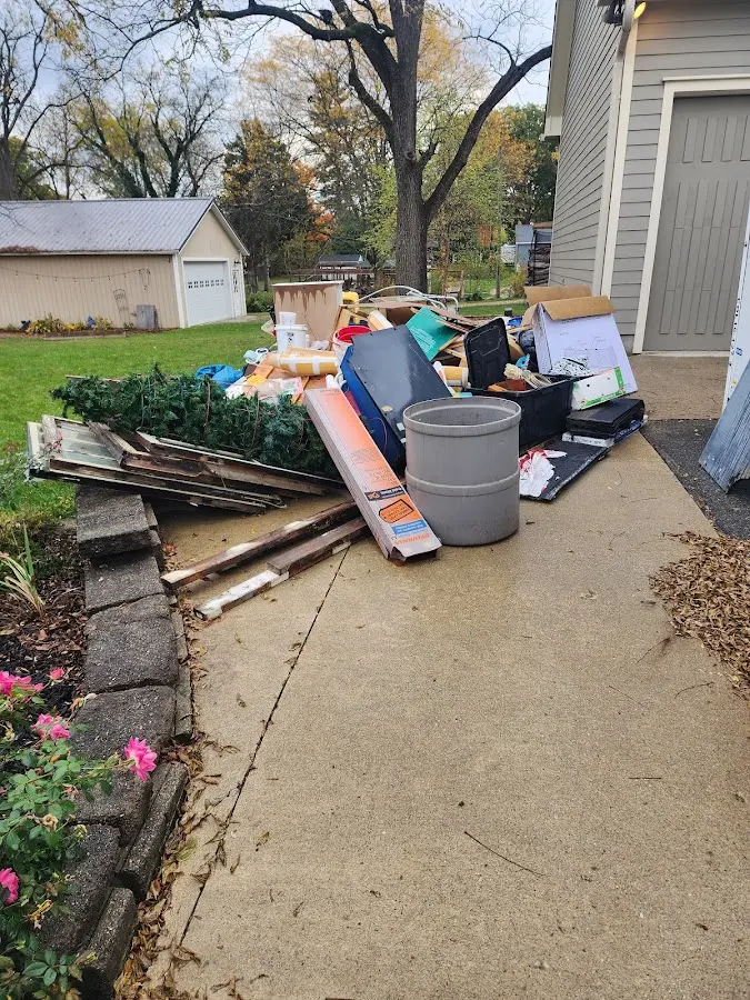 Dumpster being loaded with debris for 12 Yard Dumpster Rental in Horicon